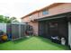 Enclosed backyard with artificial turf, storage shed and a covered screened patio at 4008 Pine Limb Ct, Tampa, FL 33614