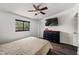 This is a clean bedroom with a ceiling fan, closet, mounted television and window at 4008 Pine Limb Ct, Tampa, FL 33614
