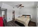 Bedroom featuring vinyl floors, a bed, a ceiling fan, and an open view of a bathroom at 4008 Pine Limb Ct, Tampa, FL 33614