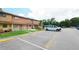 Street view of townhomes with parking spaces and grassy areas at 4008 Pine Limb Ct, Tampa, FL 33614