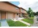 Inviting two-story townhome with a well-kept lawn and sidewalk at 4008 Pine Limb Ct, Tampa, FL 33614