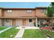 Traditional townhome featuring a cozy front porch and green lawn at 4008 Pine Limb Ct, Tampa, FL 33614