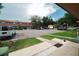 Exterior front view showcasing the townhome's reserved parking and common grounds at 4008 Pine Limb Ct, Tampa, FL 33614