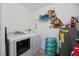 This is a laundry room with a washer, dryer, storage and water heater at 4008 Pine Limb Ct, Tampa, FL 33614
