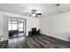 Bright living room featuring sleek wood floors and sliding glass doors to the screened lanai at 4008 Pine Limb Ct, Tampa, FL 33614