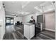 Open-concept living room and kitchen with wood floors, stainless steel appliances, and granite countertops at 4008 Pine Limb Ct, Tampa, FL 33614