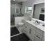 Renovated bathroom featuring marble shower, modern vanity with backlit mirror and stylish fixtures at 4029 9Th S Ave, St Petersburg, FL 33711