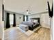 Serene main bedroom featuring a ceiling fan, hardwood floors, and ample natural light at 4029 9Th S Ave, St Petersburg, FL 33711