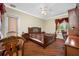 Cozy bedroom featuring hardwood floors, natural lighting, crown molding, and furniture at 4495 Secretariat Run, Spring Hill, FL 34609