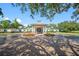 Inviting clubhouse entrance featuring brick paved drive and lush landscaping in a well manicured community at 4495 Secretariat Run, Spring Hill, FL 34609