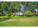 Beautifully landscaped Silverthorn community entrance with brick signage, lush lawn, and mature trees at 4495 Secretariat Run, Spring Hill, FL 34609