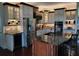 Gourmet kitchen features granite countertops, stainless steel appliances, wine storage, and a central island at 4495 Secretariat Run, Spring Hill, FL 34609