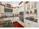 Stylish kitchen with custom cabinetry, stone backsplash, stainless steel appliances, and hardwood floors at 4495 Secretariat Run, Spring Hill, FL 34609