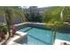 Sparkling pool surrounded by mature landscaping, creating a serene outdoor oasis at 4495 Secretariat Run, Spring Hill, FL 34609