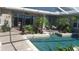 Tranquil pool area with lounge seating surrounded by lush landscaping and palm trees at 4495 Secretariat Run, Spring Hill, FL 34609
