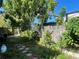 Cozy backyard with a brick pathway, lush greenery, and a wooden fence providing privacy at 4591 54Th N Ave, St Petersburg, FL 33714
