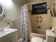 Compact bathroom featuring a shower with a shower curtain, vanity, and a window at 4591 54Th N Ave, St Petersburg, FL 33714
