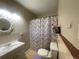 Small bathroom with a whimsical shower curtain, vanity, and toilet at 4591 54Th N Ave, St Petersburg, FL 33714