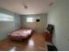 Simple bedroom design includes a bed, small TV, and two windows at 4591 54Th N Ave, St Petersburg, FL 33714