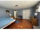 Comfortable bedroom features wood floors, a bed, and a closet for storage at 4591 54Th N Ave, St Petersburg, FL 33714