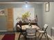 Casual dining room featuring a wooden table, folding chairs, and a decorative sideboard at 4591 54Th N Ave, St Petersburg, FL 33714