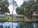 Beautiful backyard with lush landscaping and views of the tranquil pond and neighboring homes at 4617 Basswood St, Land O Lakes, FL 34639