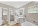 Bright bathroom featuring a walk-in shower, soaking tub and vanity with ample storage at 4617 Basswood St, Land O Lakes, FL 34639