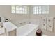 Bright bathroom showcasing a soaking tub, glass block window, and towel rack at 4617 Basswood St, Land O Lakes, FL 34639