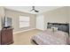 Cozy bedroom featuring light wood floors, a ceiling fan, and a closet at 4617 Basswood St, Land O Lakes, FL 34639