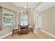 Cozy breakfast nook features wood table with modern lighting and large windows at 4617 Basswood St, Land O Lakes, FL 34639