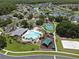 Aerial shot showcases the community pool, playground, and lush landscaping at 4617 Basswood St, Land O Lakes, FL 34639