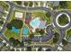 Aerial view of community amenities, including a pool, playground, basketball courts, and ample parking at 4617 Basswood St, Land O Lakes, FL 34639
