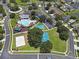 Aerial view of the community amenities including the pool, playground, and sports courts at 4617 Basswood St, Land O Lakes, FL 34639