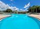 Inviting community pool with ample seating and a clubhouse, perfect for relaxation and social gatherings at 4617 Basswood St, Land O Lakes, FL 34639