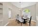Traditional dining area features a pendant light, arched window and wood table with seating for four at 4617 Basswood St, Land O Lakes, FL 34639