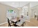 Formal dining room boasts a modern chandelier, arched window, and wood table with seating for four at 4617 Basswood St, Land O Lakes, FL 34639