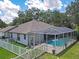 Charming single-Gathering home features a screened-in pool area and fenced yard with mature trees at 4617 Basswood St, Land O Lakes, FL 34639