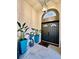 An elegant front door with decorative planters and an arched entryway at 4617 Basswood St, Land O Lakes, FL 34639