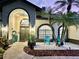 Beautiful home with a landscaped front yard and a covered front entryway at dusk at 4617 Basswood St, Land O Lakes, FL 34639