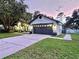 Well-maintained home featuring a spacious garage, manicured lawn, and inviting exterior lighting at dusk at 4617 Basswood St, Land O Lakes, FL 34639