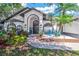 Stunning home with a manicured lawn, lush landscaping, and a covered front entry at 4617 Basswood St, Land O Lakes, FL 34639