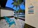 Quaint outdoor seating area with palm trees and beach-themed decor at 4617 Basswood St, Land O Lakes, FL 34639
