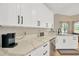 Bright kitchen with white cabinets, sleek black hardware, modern appliances, and quartz countertops at 4617 Basswood St, Land O Lakes, FL 34639