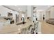 Bright kitchen features stainless steel appliances, white cabinetry and a large marble center island at 4617 Basswood St, Land O Lakes, FL 34639