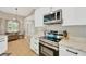 Stylish kitchen features stainless steel appliances, white cabinets, and an adjacent breakfast nook at 4617 Basswood St, Land O Lakes, FL 34639