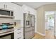 Bright modern kitchen features stainless steel appliances, white cabinetry, and a convenient layout at 4617 Basswood St, Land O Lakes, FL 34639