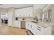 Clean kitchen with stainless appliances, white cabinetry, light countertops, and eat-in breakfast area at 4617 Basswood St, Land O Lakes, FL 34639