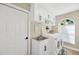 Well-organized laundry room featuring white cabinets, a stainless steel sink and a washer and dryer at 4617 Basswood St, Land O Lakes, FL 34639