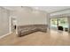 Bright living room featuring a plush sectional sofa and sliding glass doors to the pool at 4617 Basswood St, Land O Lakes, FL 34639