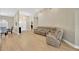 Spacious living room with a comfortable sectional, bright natural light, and wood-look floors at 4617 Basswood St, Land O Lakes, FL 34639